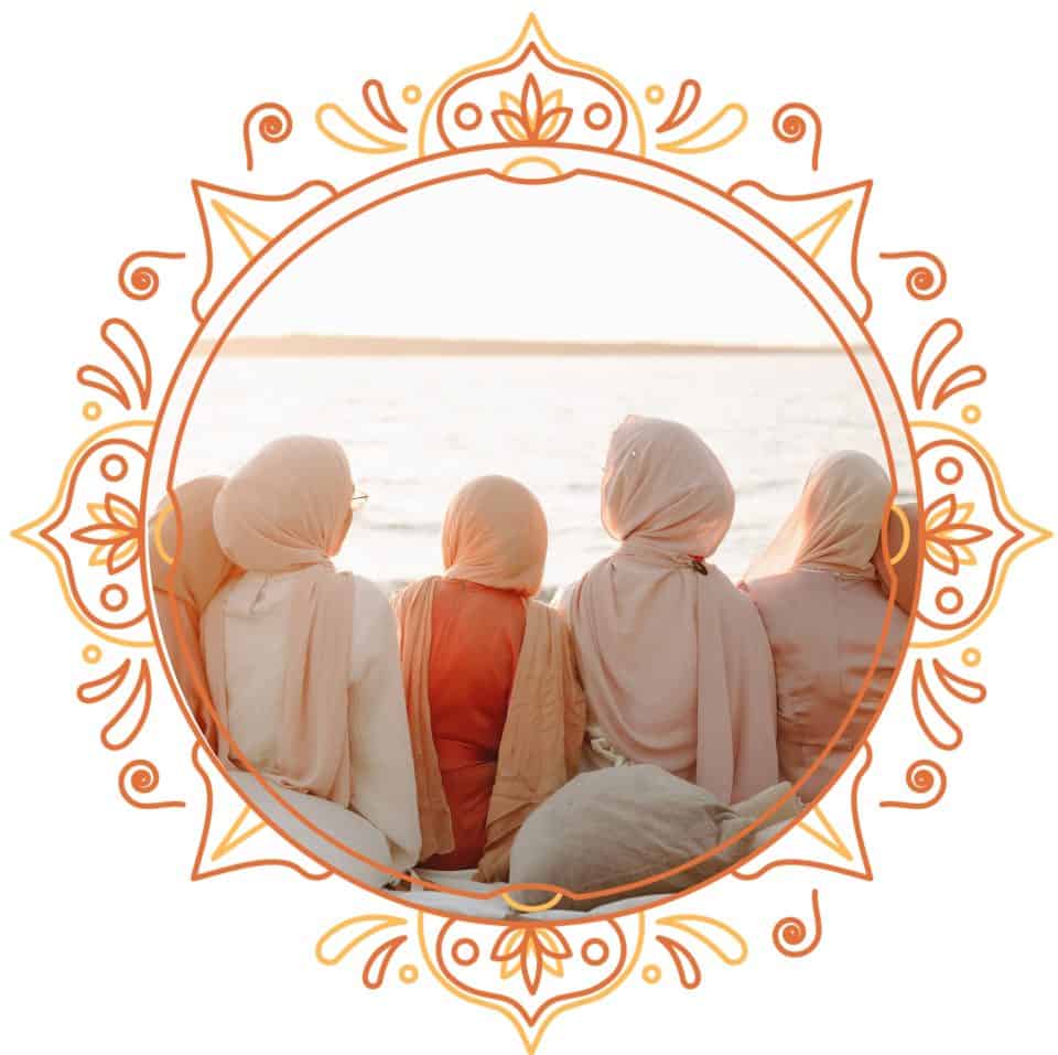 Muslim women looking towards the sea